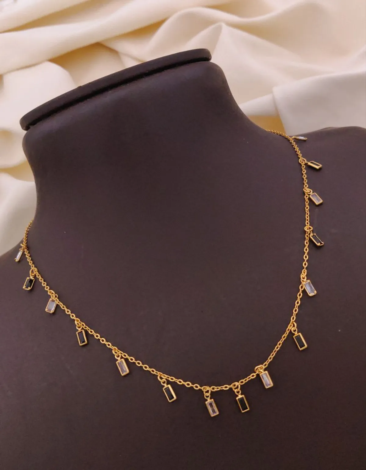 Minimalist gold necklace with rectangular and circular charms